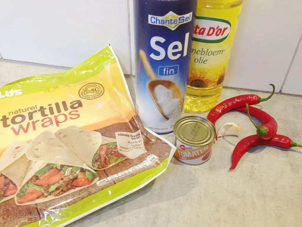 Homemade tortilla chips with red chilli dipping sauce ingredients