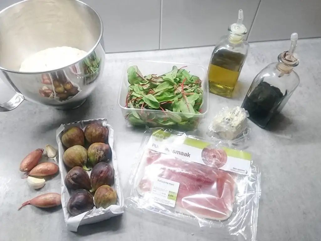 Fig-prosciutto pizza with purple baby spinach ingredients