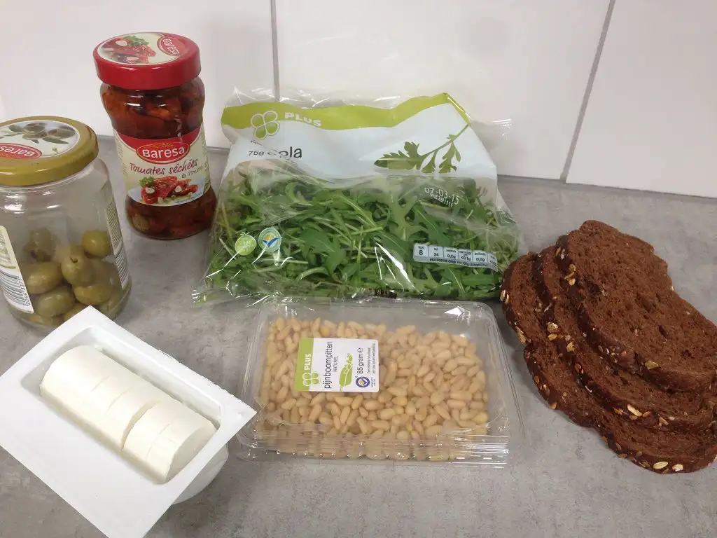 Goat cheese, sun-dried tomato and olive open sandwich ingredients