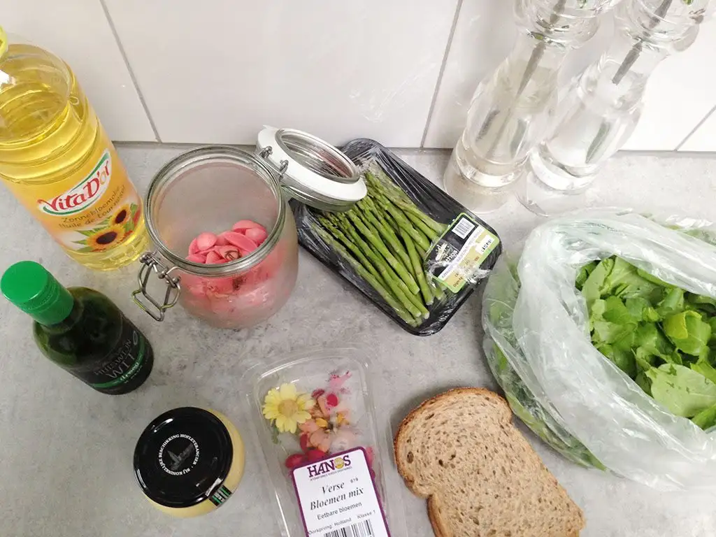 Green asparagus salad with edible flowers ingredients