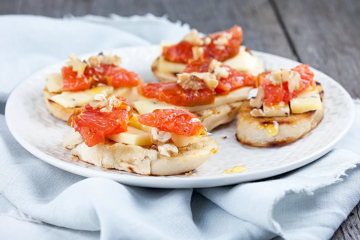 Truffle cheese and grapefruit crostini