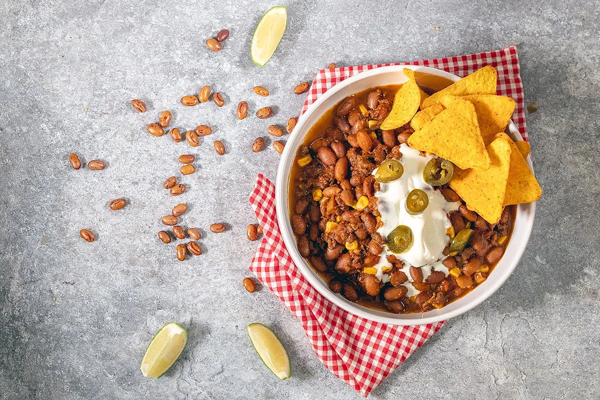 Hearty mexican bean stew with minced meat and corn