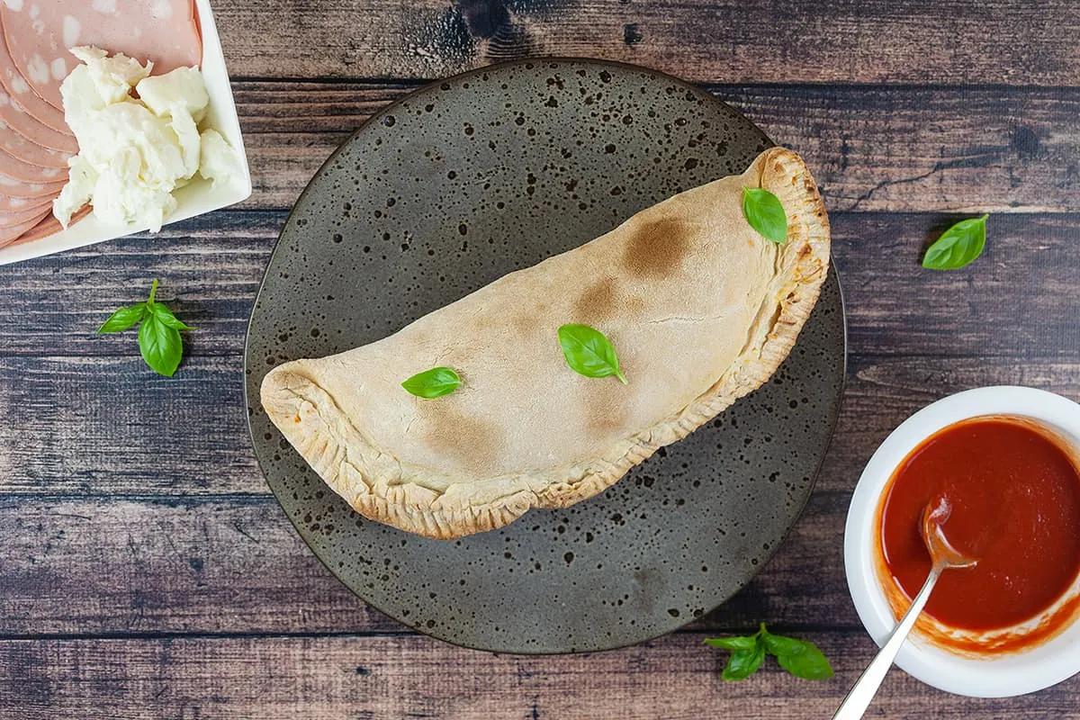 Pizza calzone - folded pizza with a tasty filling