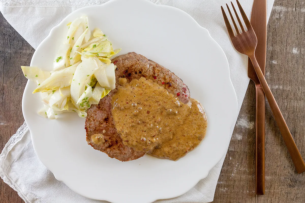 Steak with pink peppercorn sauce
