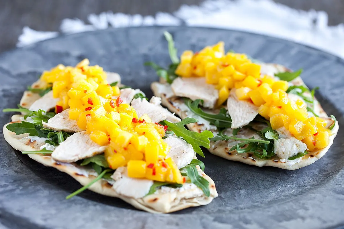 Mango and chicken with goat cheese on naan bread