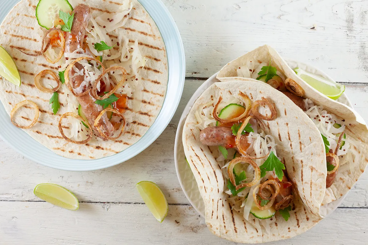Tortillas with sausages, white cabbage and crispy onions