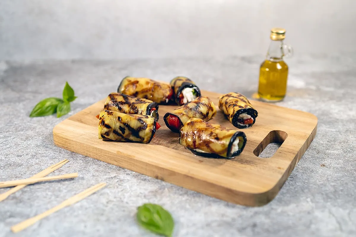 Grilled eggplant roll-ups filled with mozzarella cheese and basil