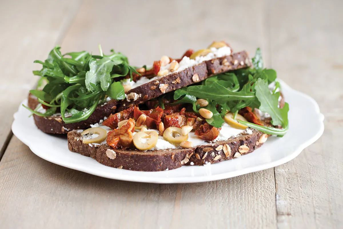 Goat cheese, sun-dried tomato and olive open sandwich