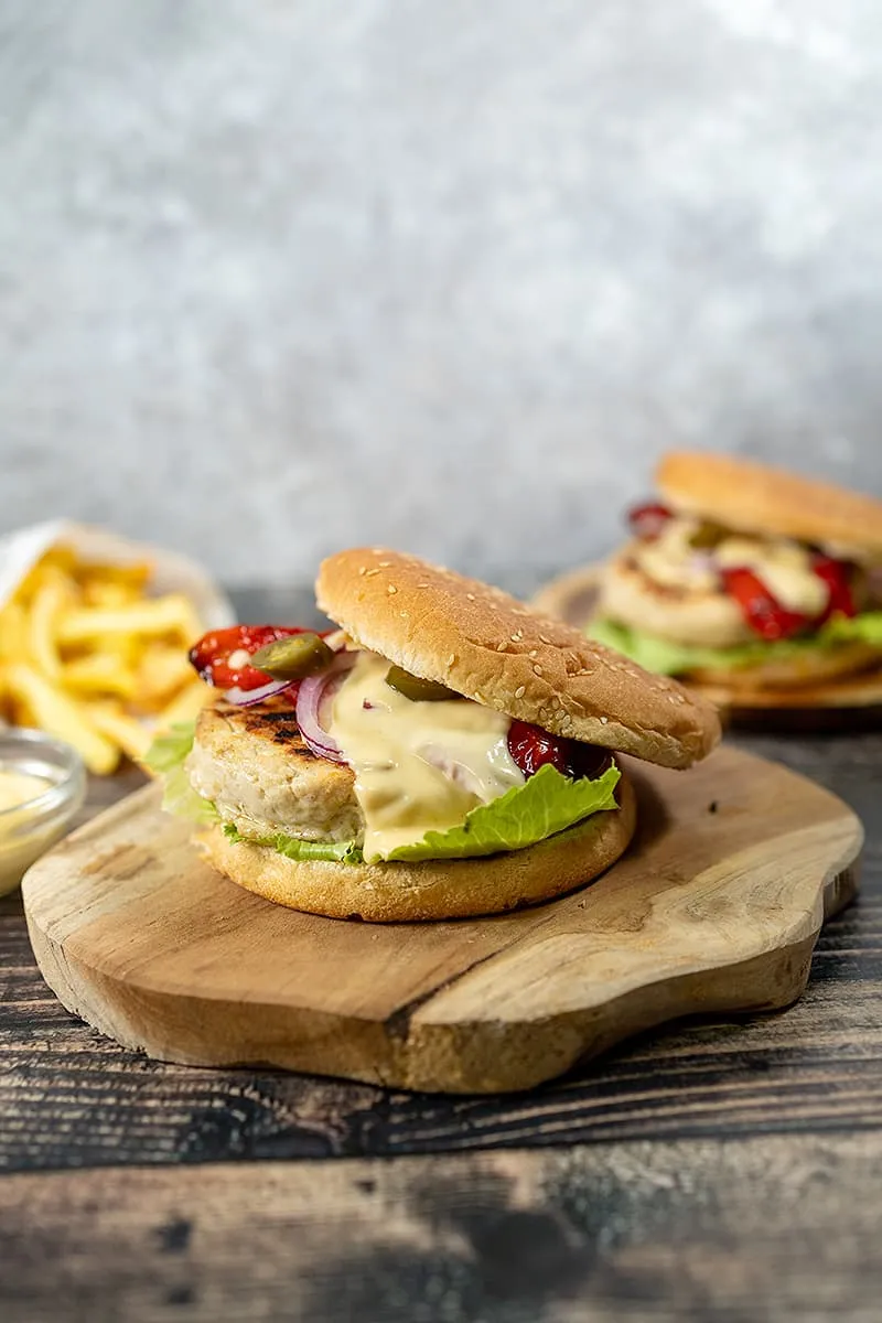 Turkey burgers with cheese sauce and grilled peppers